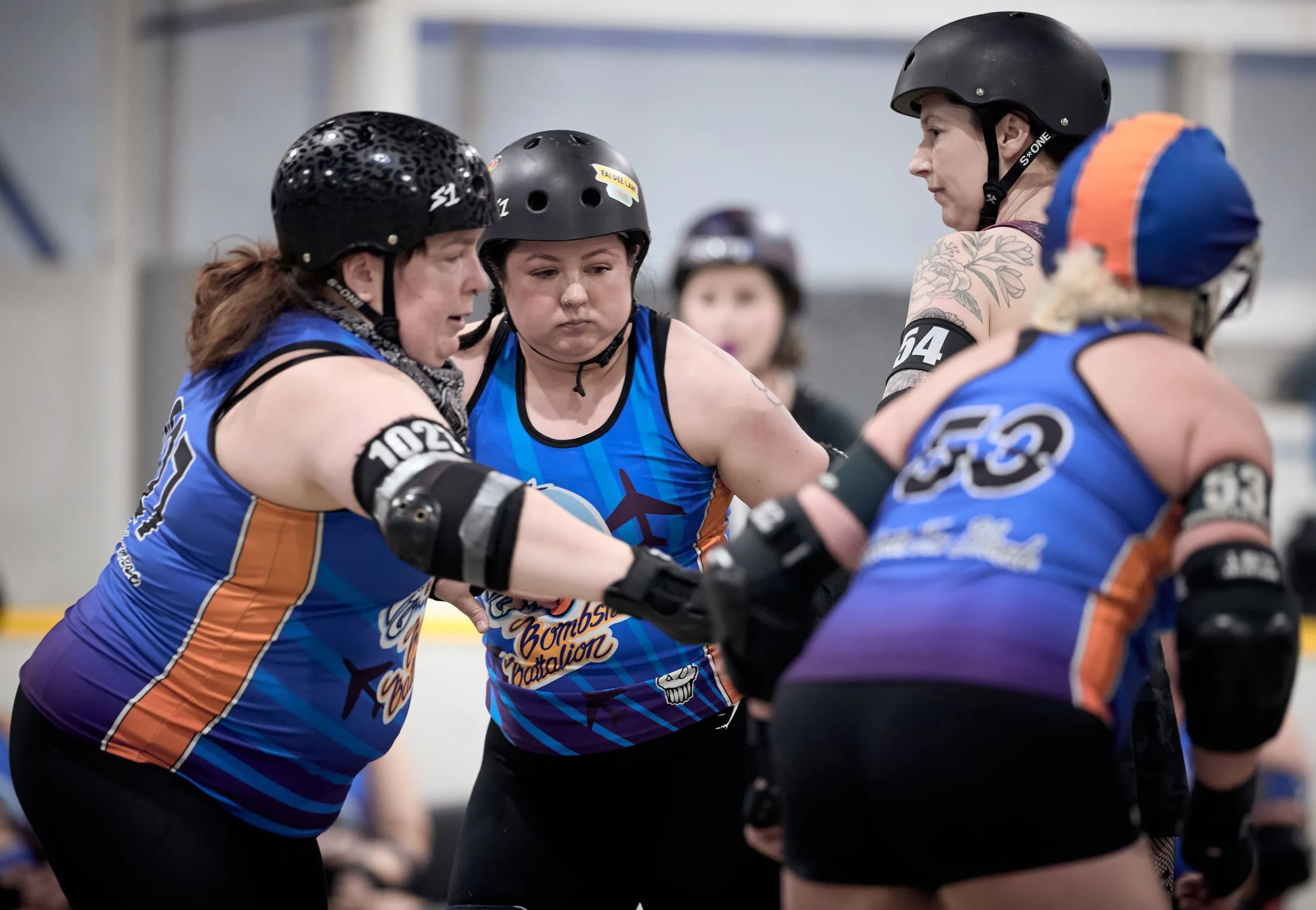 Bombshell Battalion blockers brace shoulder to shoulder against an opposing jammer