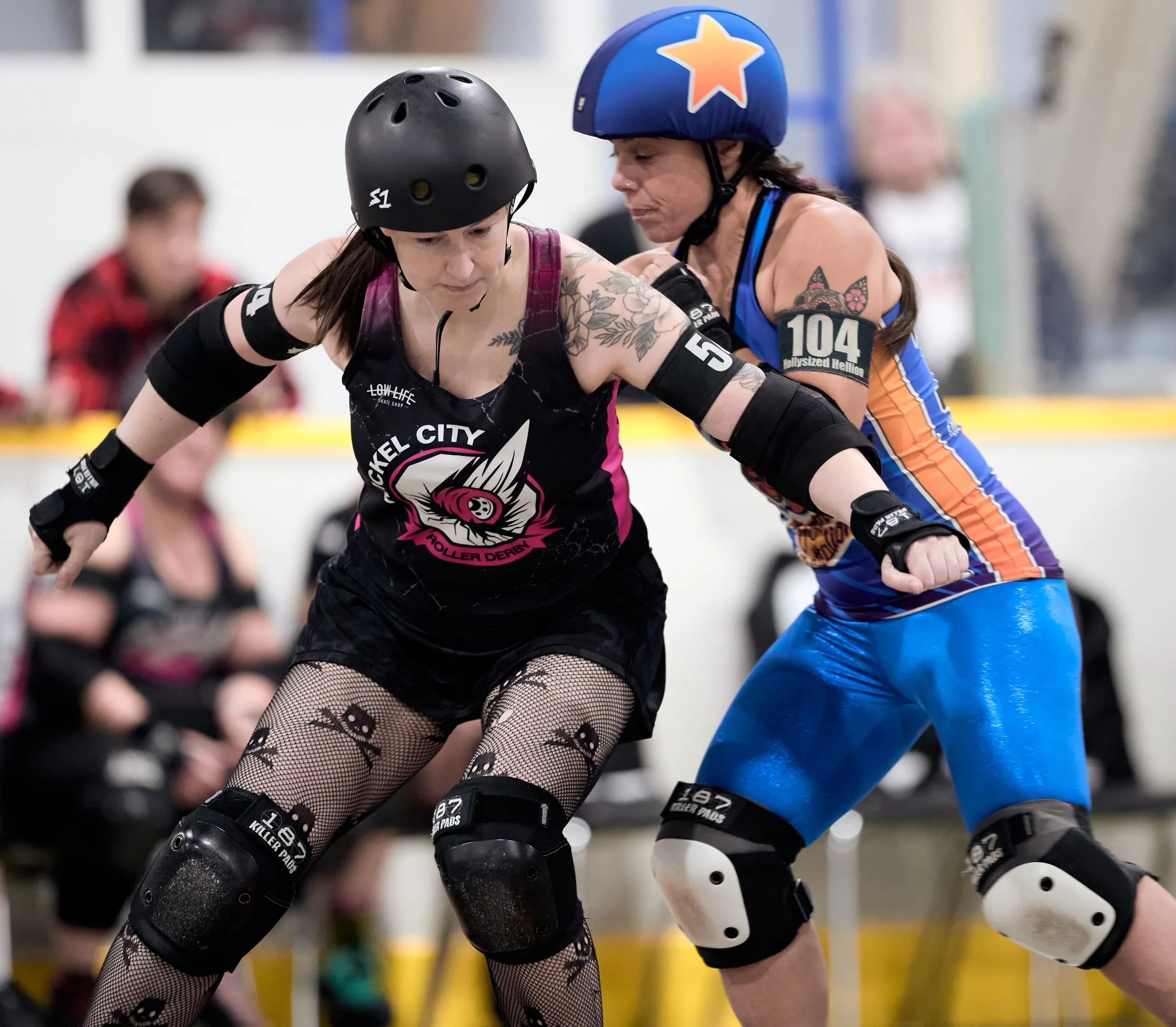 Bombshell Battalion jammer Holly, number 104, pushes past a Nickel City blocker